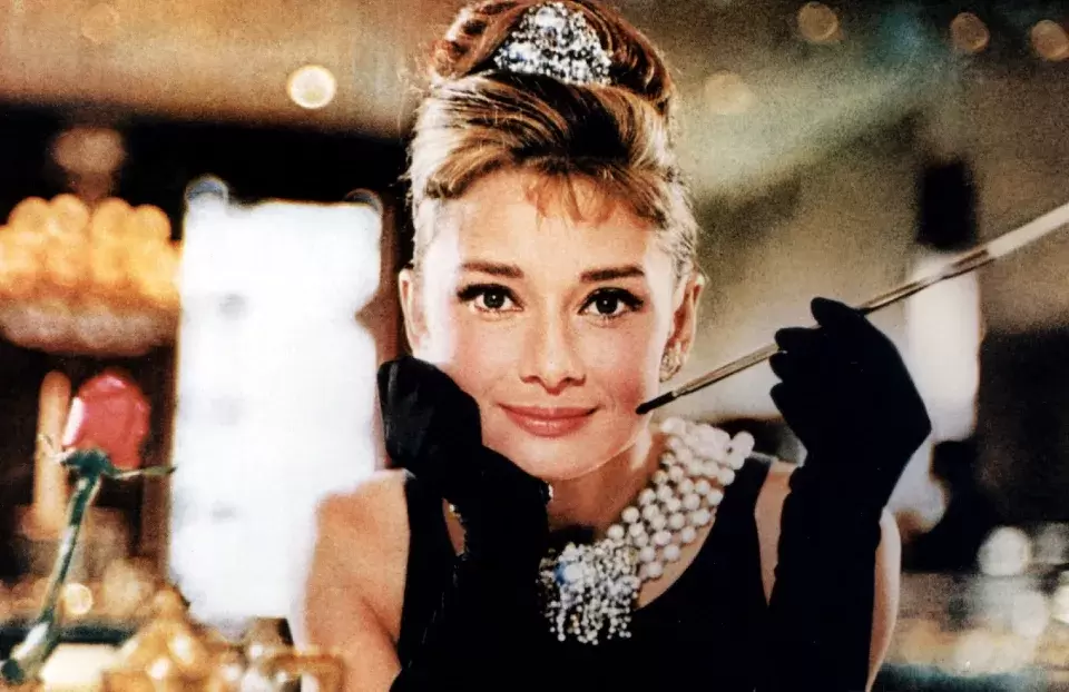 PicturAudrey Hepburn as Holly Golightly in Breakfast at Tiffany's, complete with diamonds and cigarette holder.e